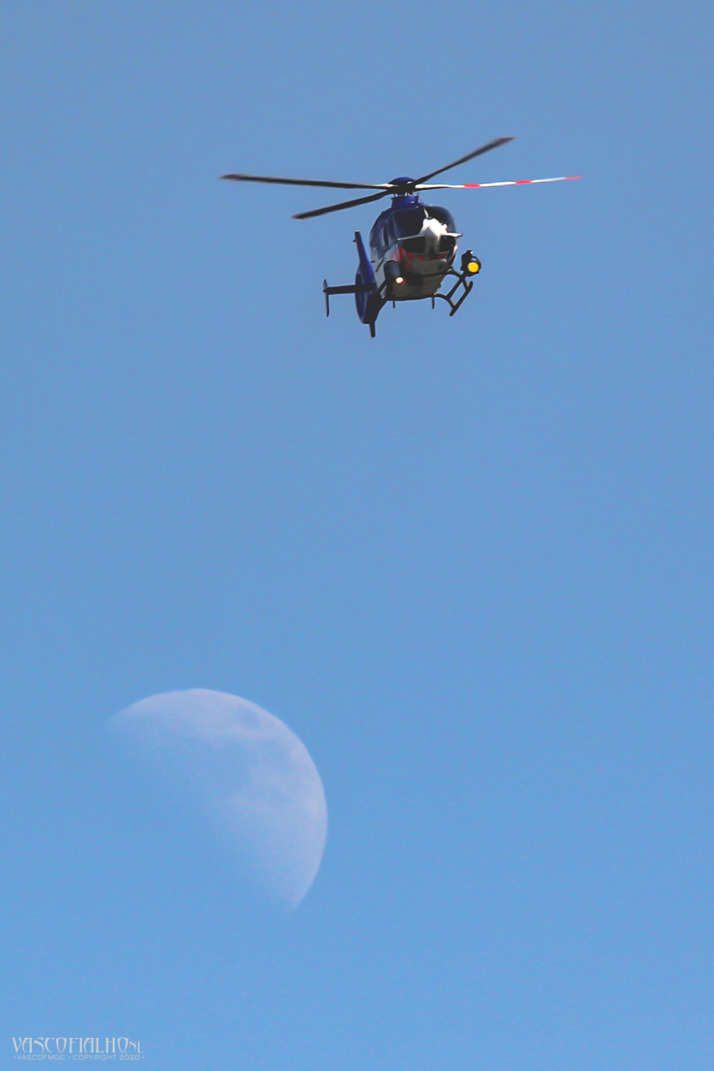 Police chopper flying over the moon